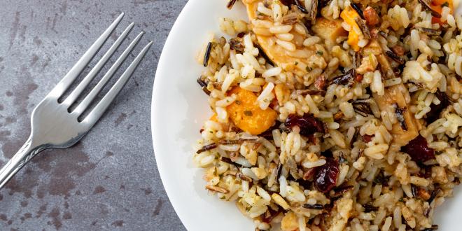 a plate of wild rice stuffing with fruit